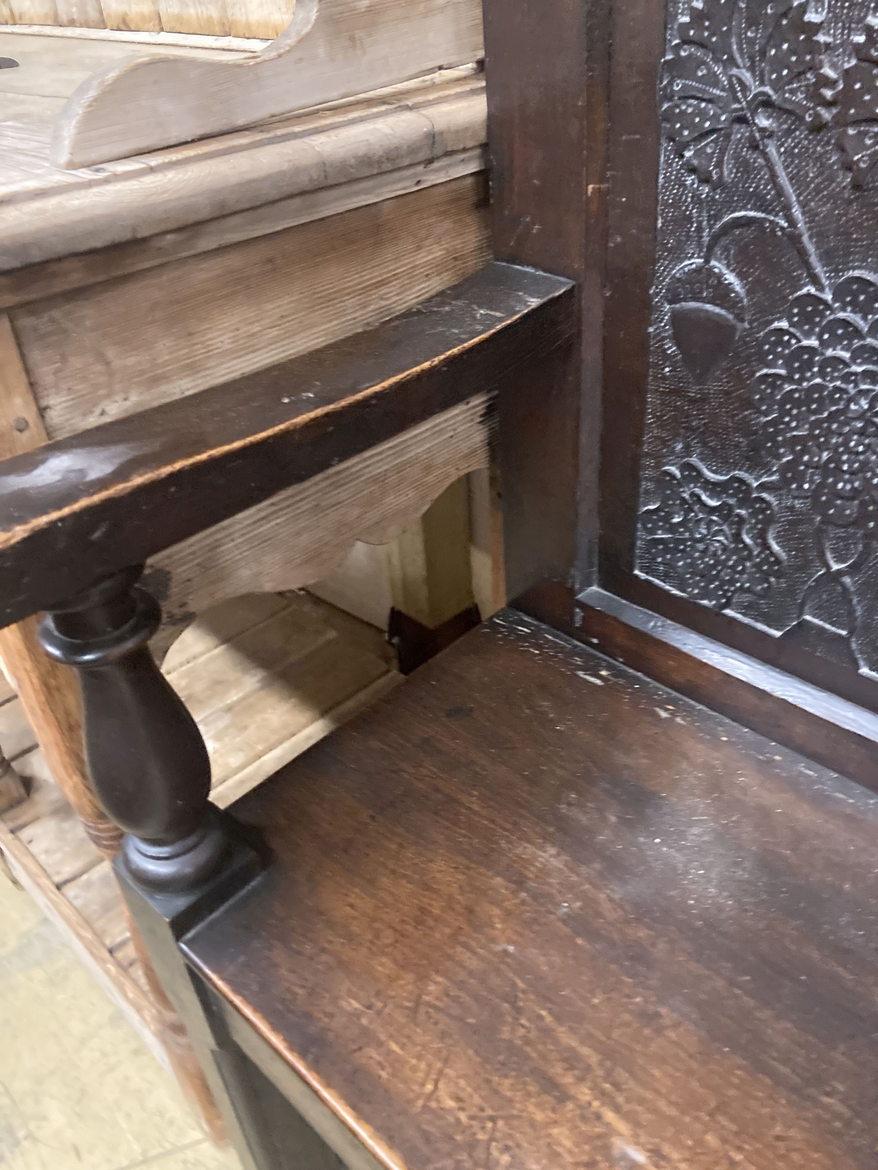 A 19th century oak settle incorporating 17th century panels, width 137cm, depth 44cm, height 131cm